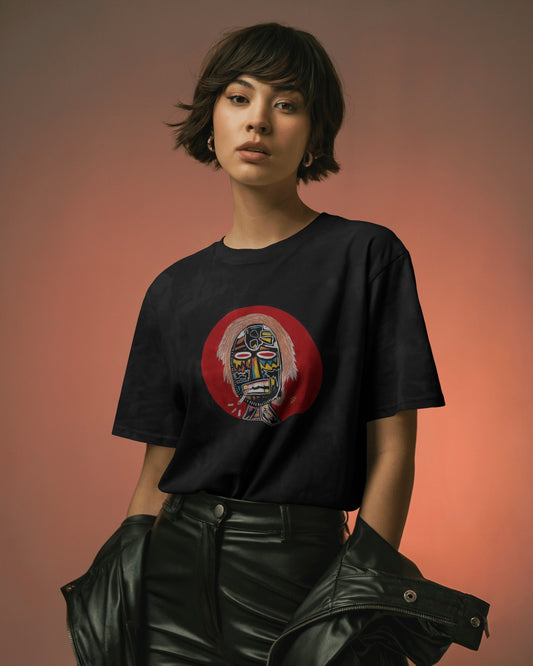 Person wearing the Masked Face Graphic Tee – a unisex oversized streetwear t-shirt with a bold tribal-inspired design on a brown background.