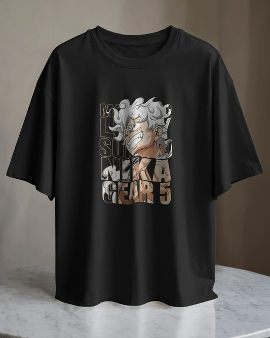 Gear 5 Awakening Nika Mode Baggy Fit Anime Tee. Black baggy fit t-shirt displayed flat, showing the Gear 5 Awakening Nika Mode graphic on the front.